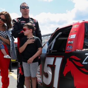 NASCAR Craftsman Truck Series driver Kyle Busch stands with his wife Samantha Busch and children Brexton and Lennix prior to the CRC Brakleen 150 at Pocono Raceway.