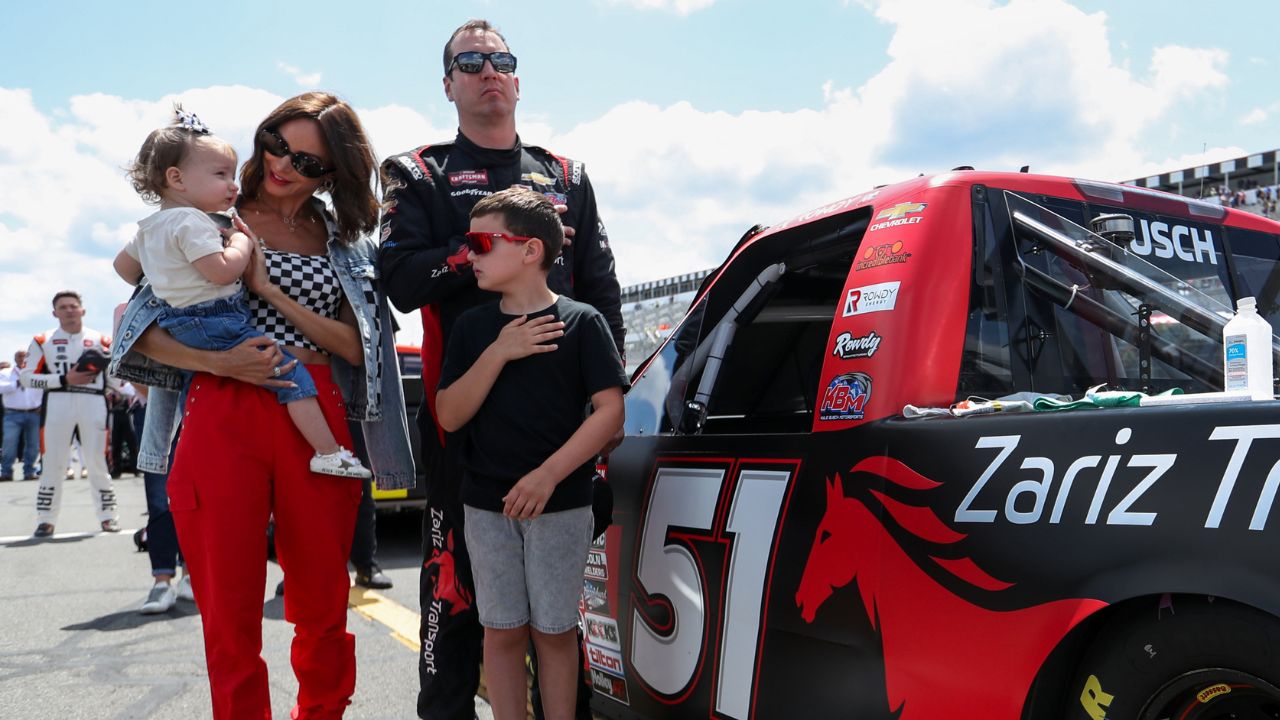 NASCAR Craftsman Truck Series driver Kyle Busch stands with his wife Samantha Busch and children Brexton and Lennix prior to the CRC Brakleen 150 at Pocono Raceway.