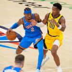 Oklahoma City Thunder guard Shai Gilgeous-Alexander (2) dribbles the ball against Indiana Pacers guard Bennedict Mathurin (00) during the second half during game two of the 2025 NBA Finals at Paycom Center.