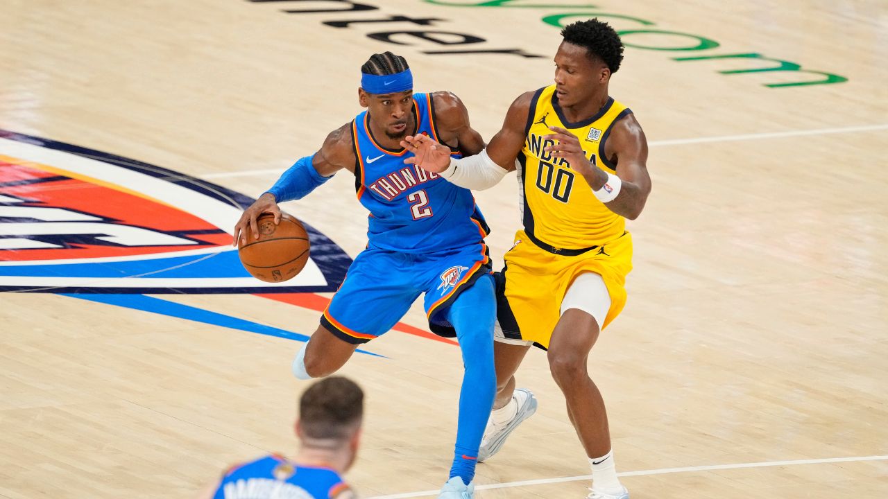 Oklahoma City Thunder guard Shai Gilgeous-Alexander (2) dribbles the ball against Indiana Pacers guard Bennedict Mathurin (00) during the second half during game two of the 2025 NBA Finals at Paycom Center.