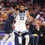 Dallas Mavericks guard Kyrie Irving (11) dribbles against Minnesota Timberwolves center Karl-Anthony Towns (32) during the first quarter of game four of the western conference finals for the 2024 NBA playoffs at American Airlines Center