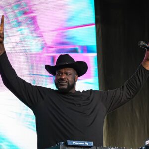 Shaquille O'Neal holds up the sign of the horns during a DJ performance ahead of the College Football Playoff semifinal game between the Texas Longhorns and Ohio State in the Cotton Bowl at AT&T Stadium on Friday, Jan. 10, 2024 in Arlington, Texas.