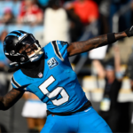 Carolina Panthers wide receiver Diontae Johnson (5) celebrates by throwing the ball into the crowd after scoring a thouchdown