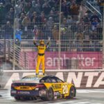 NASCAR Cup Series driver Christopher Bell (20) does his celebratory waves at the crowd after claiming a victory at Atlanta Motor Speedway.