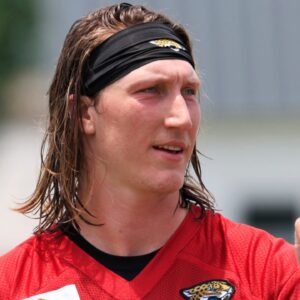 Jacksonville Jaguars quarterback Trevor Lawrence (16) fist bumps executive vice president of football operations Tony Boselli during the first organized team activity at Miller Electric Center Monday, May 19, 2025 in Jacksonville, Fla.