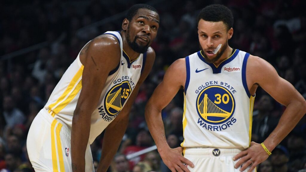 Golden State Warriors guard Stephen Curry (30) and forward Kevin Durant (35) react in the first half of game six of the first round of the 2019 NBA Playoffs against the LA Clippers at Staples Center.