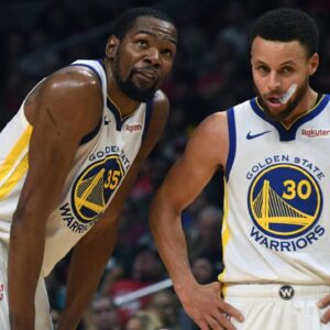 Golden State Warriors guard Stephen Curry (30) and forward Kevin Durant (35) react in the first half of game six of the first round of the 2019 NBA Playoffs against the LA Clippers at Staples Center.