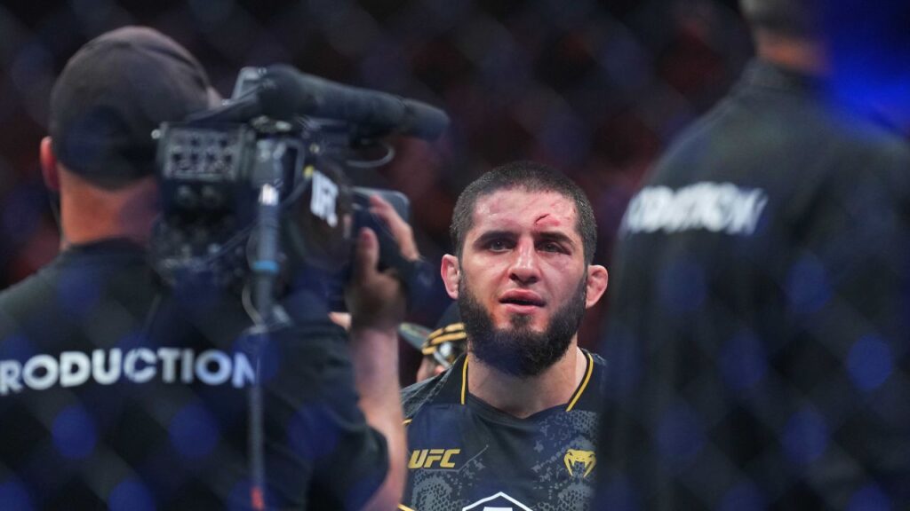 Islam Makhachev (red gloves) celebrates defeating Dustin Poirier (blue gloves) during UFC 302 at Prudential Center.