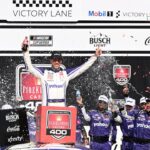NASCAR Cup Series driver Denny Hamlin (11) celebrates with his team after winning the FireKeepers Casino 400 at Michigan International Speedway.