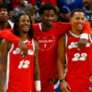 Dec 19, 2024; Memphis, Tennessee, USA; Memphis Grizzlies guard Ja Morant (left), forward Jaren Jackson Jr. (middle) and guard Desmond Bane (right) react during the fourth quarter against the Golden State Warriors at FedExForum. Mandatory Credit: Petre Thomas-Imagn Images