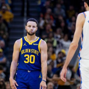 Golden State Warriors guard Stephen Curry (30) and Oklahoma City Thunder center Chet Holmgren (7) on the court during the second half at Chase Center.