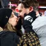 Recording artist Taylor Swift and Kansas City Chiefs tight end Travis Kelce (87) react after the AFC Championship game against the Buffalo Bills at GEHA Field at Arrowhead Stadium.