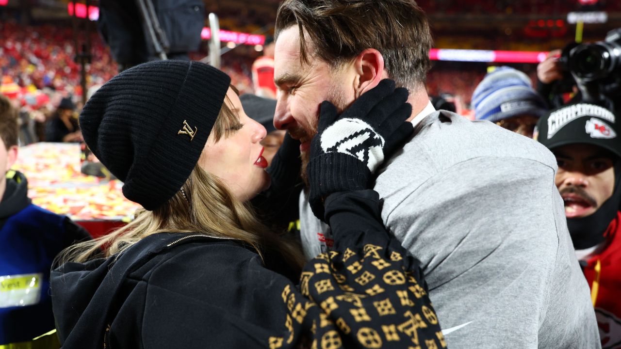 Recording artist Taylor Swift and Kansas City Chiefs tight end Travis Kelce (87) react after the AFC Championship game against the Buffalo Bills at GEHA Field at Arrowhead Stadium.