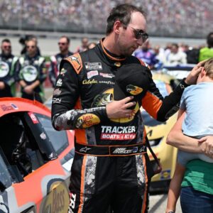 NASCAR Cup Series driver Chase Briscoe (19) with his son Brooks and his wife Marissa before the start of the FireKeepers Casino 400 at Michigan International Speedway.