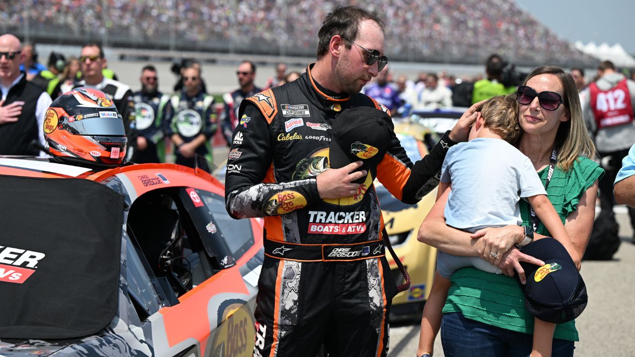 NASCAR Cup Series driver Chase Briscoe (19) with his son Brooks and his wife Marissa before the start of the FireKeepers Casino 400 at Michigan International Speedway.