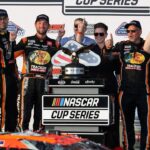 NASCAR Cup Series driver Chase Briscoe celebrates with his team in victory lane after winning The Great American Getaway 400 at Pocono Raceway.