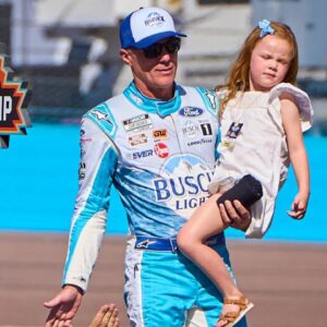 Holding his daughter Piper, NASCAR Cup Series driver Kevin Harvick (4) walks the catwalk during the driver introductions for the Cup Series Championship race at Phoenix Raceway in Avondale on Nov. 5, 2023.
