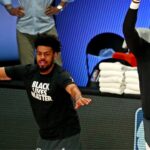 Aug 29, 2020; Lake Buena Vista, Florida, USA; Los Angeles Lakers forward LeBron James (23) celebrates with guard Quinn Cook (28) before playing the Portland Trail Blazers in game five of the first round of the 2020 NBA Playoffs at AdventHealth Arena.