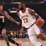 Phoenix Suns forward Kelly Oubre Jr. (3) guards Los Angeles Lakers forward LeBron James (23) as he drives to the basket in the first half of the game at Staples Center.
