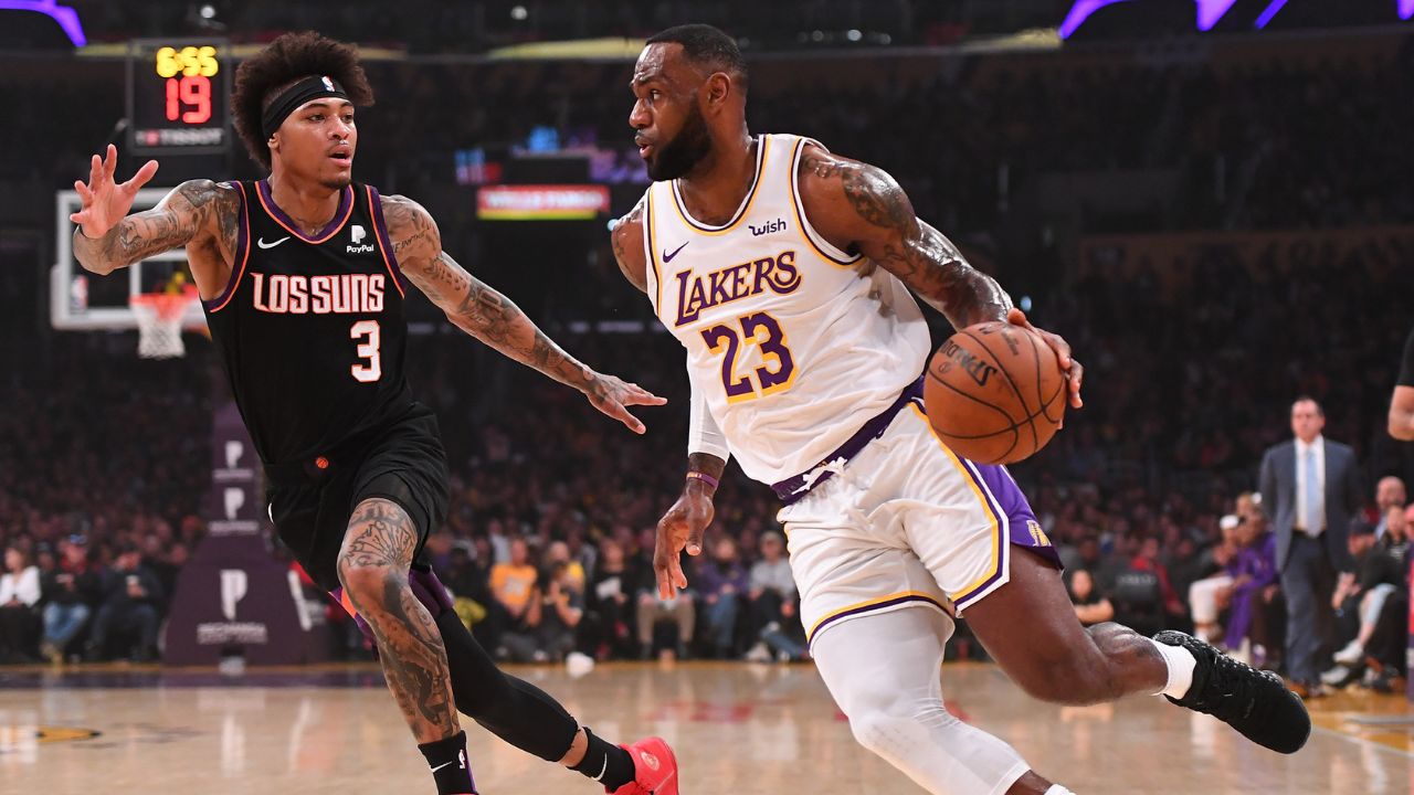 Phoenix Suns forward Kelly Oubre Jr. (3) guards Los Angeles Lakers forward LeBron James (23) as he drives to the basket in the first half of the game at Staples Center.