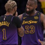 Nov 21, 2024; Los Angeles, California, USA; Los Angeles Lakers guard D'Angelo Russell (1) and forward LeBron James (23) talk on the court during a stoppage in play against the Orlando Magic at Crypto.com Arena