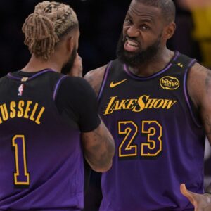 Nov 21, 2024; Los Angeles, California, USA; Los Angeles Lakers guard D'Angelo Russell (1) and forward LeBron James (23) talk on the court during a stoppage in play against the Orlando Magic at Crypto.com Arena