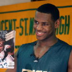 LeBron James holds an issue of Sports Illustrated on Feb. 13, 2002. James was on SI’s cover as a junior at St. Vincent-St. Mary High School.