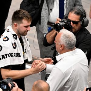 Los Angeles Lakers guard Luka Doncic (77) hugs his father Sasa Doncic after the game against the Dallas Mavericks at the American Airlines Center.