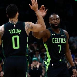 Boston Celtics guard Jaylen Brown (7) high fives forward Jayson Tatum (0) after the Cleveland Cavaliers called a timeout during the first quarter at TD Garden