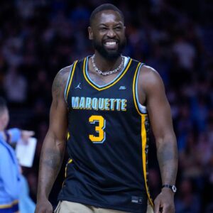 Former Marquette Golden Eagles player Dwyane Wade smiles timeout during the first half of the game against the Providence Friars at Fiserv Forum.