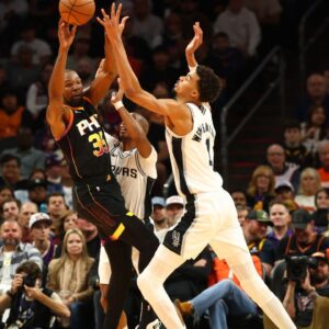Phoenix Suns forward Kevin Durant (35) against San Antonio Spurs center Victor Wembanyama (1) in the first half of an NBA Cup game at Footprint Center.