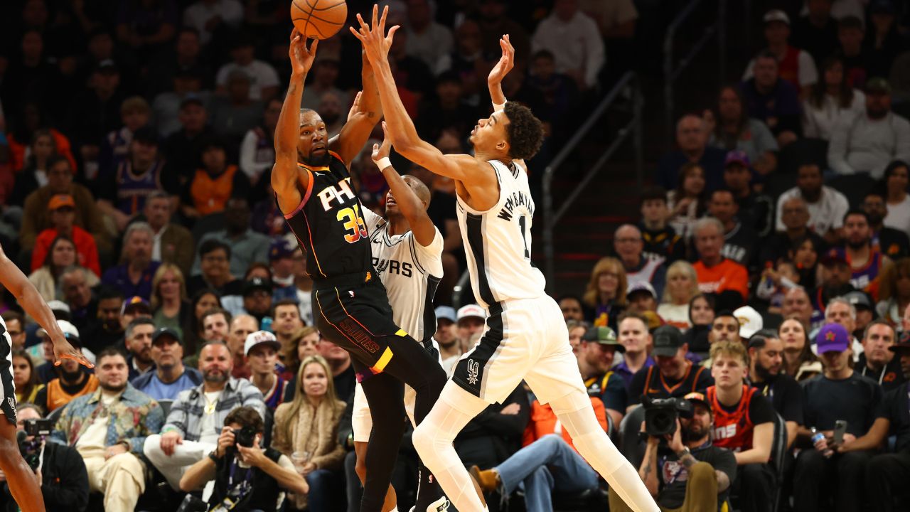 Phoenix Suns forward Kevin Durant (35) against San Antonio Spurs center Victor Wembanyama (1) in the first half of an NBA Cup game at Footprint Center.