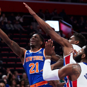Nov 27, 2018; Detroit, MI, USA; New York Knicks guard Damyean Dotson (21) goes to the basket on Detroit Pistons guard Langston Galloway (9) and center Andre Drummond (0) in the second half at Little Caesars Arena. Mandatory Credit: Rick Osentoski-Imagn Images