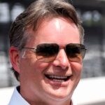 Inaugural Brickyard 400 winner Jeff Gordon stands on the track with other drivers from the first race Sunday, July 21, 2024, ahead of the Brickyard 400 at Indianapolis Motor Speedway.