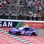 NASCAR Cup Series driver Denny Hamlin (11) crosses the finish line to win the FireKeepers Casino 400 at Michigan International Speedway.