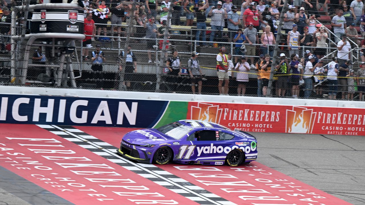 NASCAR Cup Series driver Denny Hamlin (11) crosses the finish line to win the FireKeepers Casino 400 at Michigan International Speedway.