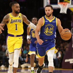 Oct 13, 2023; Los Angeles, California, USA; Golden State Warriors guard Stephen Curry (30) dribbles the ball against Los Angeles Lakers guard D'Angelo Russell (1) during the second quarter at Crypto.com Arena. Mandatory Credit: Kiyoshi Mio-Imagn Images
