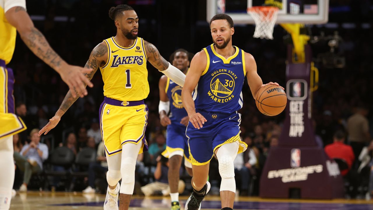 Oct 13, 2023; Los Angeles, California, USA; Golden State Warriors guard Stephen Curry (30) dribbles the ball against Los Angeles Lakers guard D'Angelo Russell (1) during the second quarter at Crypto.com Arena. Mandatory Credit: Kiyoshi Mio-Imagn Images