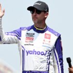 NASCAR Cup Series driver Denny Hamlin (11) greets the crowd during driver introductions before the start of the FireKeepers Casino 400 at Michigan International Speedway.