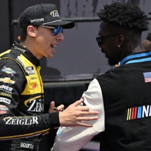NASCAR Cup Series driver Carson Hocevar (77) greets Detroit Lions safety Kerby Joseph during driver introductions before the start of the FireKeepers Casino 400 at Michigan International Speedway.