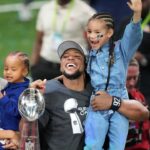 Philadelphia Eagles running back Saquon Barkley celebrates with fiancee Anna Congdon, son Saquon Barkley Jr.,2, and daughter Jada Barkley 6, after the Philadelphia Eagles 40-22 victory over the Kansas City Chiefs in Super Bowl LIX at the Caesars Superdome.