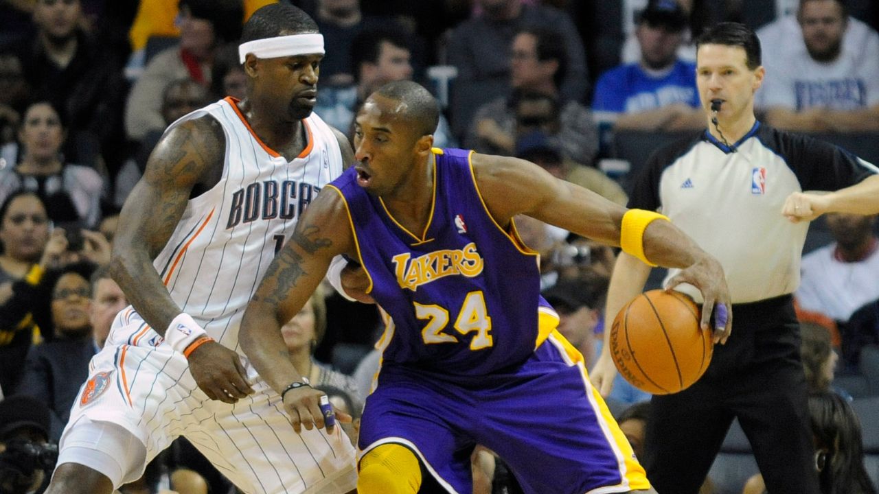 Los Angeles Lakers guard Kobe Bryant (24) drives against Charlotte Bobcats guard forward Stephen Jackson (1) during the game at Time Warner Cable Arena.