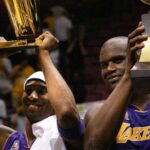 June 12, 2002; East Rutherford, NJ; The Lakers Kobe Bryant holds up the Championship trophy along with teammate Shaquille O'Neal who holds up his third MVP trophy.