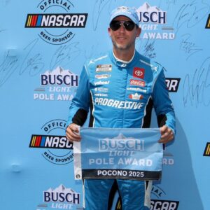 NASCAR Cup Series driver Denny Hamlin stands with the Busch Light Pole Award after winning the pole for The Great American Getaway 400 at Pocono Raceway.
