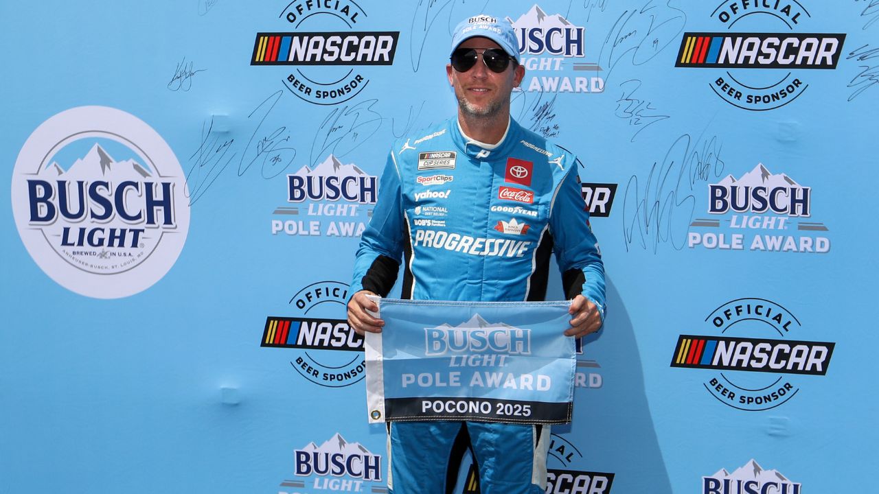 NASCAR Cup Series driver Denny Hamlin stands with the Busch Light Pole Award after winning the pole for The Great American Getaway 400 at Pocono Raceway.