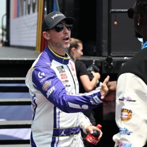 NASCAR Cup Series driver Denny Hamlin (11) greets Detroit Lions safety Kerby Joseph during driver introductions before the start of the FireKeepers Casino 400 at Michigan International Speedway.