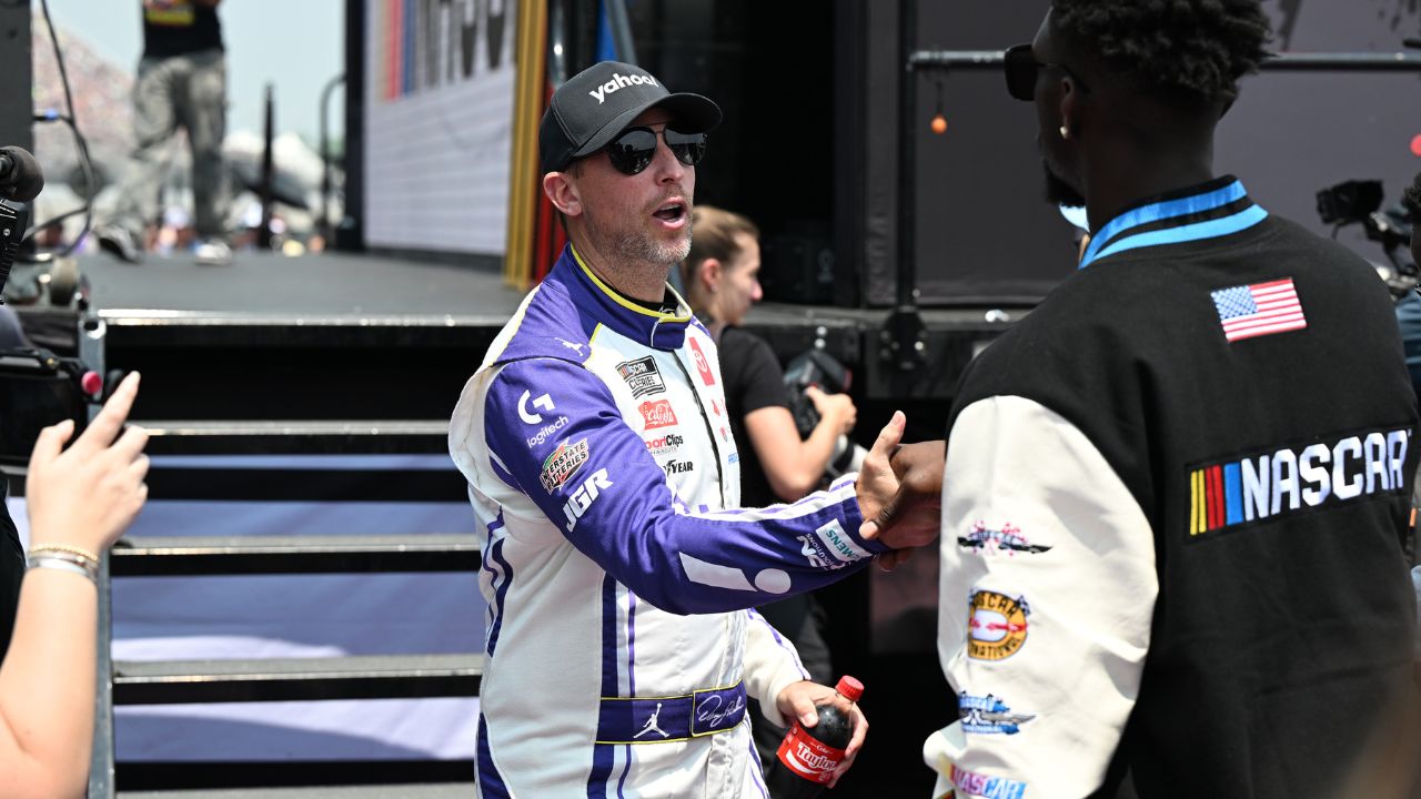 NASCAR Cup Series driver Denny Hamlin (11) greets Detroit Lions safety Kerby Joseph during driver introductions before the start of the FireKeepers Casino 400 at Michigan International Speedway.