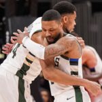 Milwaukee Bucks forward Giannis Antetokounmpo (34) and guard Damian Lillard (0) react after defeating the Atlanta Hawks at State Farm Arena.