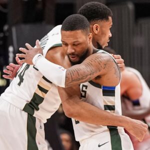 Milwaukee Bucks forward Giannis Antetokounmpo (34) and guard Damian Lillard (0) react after defeating the Atlanta Hawks at State Farm Arena.