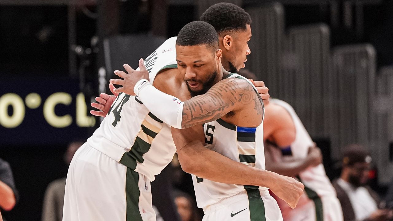 Milwaukee Bucks forward Giannis Antetokounmpo (34) and guard Damian Lillard (0) react after defeating the Atlanta Hawks at State Farm Arena.